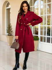 Red tailored double-breasted trench coat with waist tie and pearl buttons