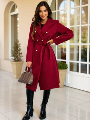 Red tailored double-breasted trench coat with waist tie and pearl buttons