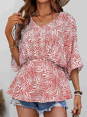 Abstract print cinched waist blouse with V-neck and short sleeves in scarlet.