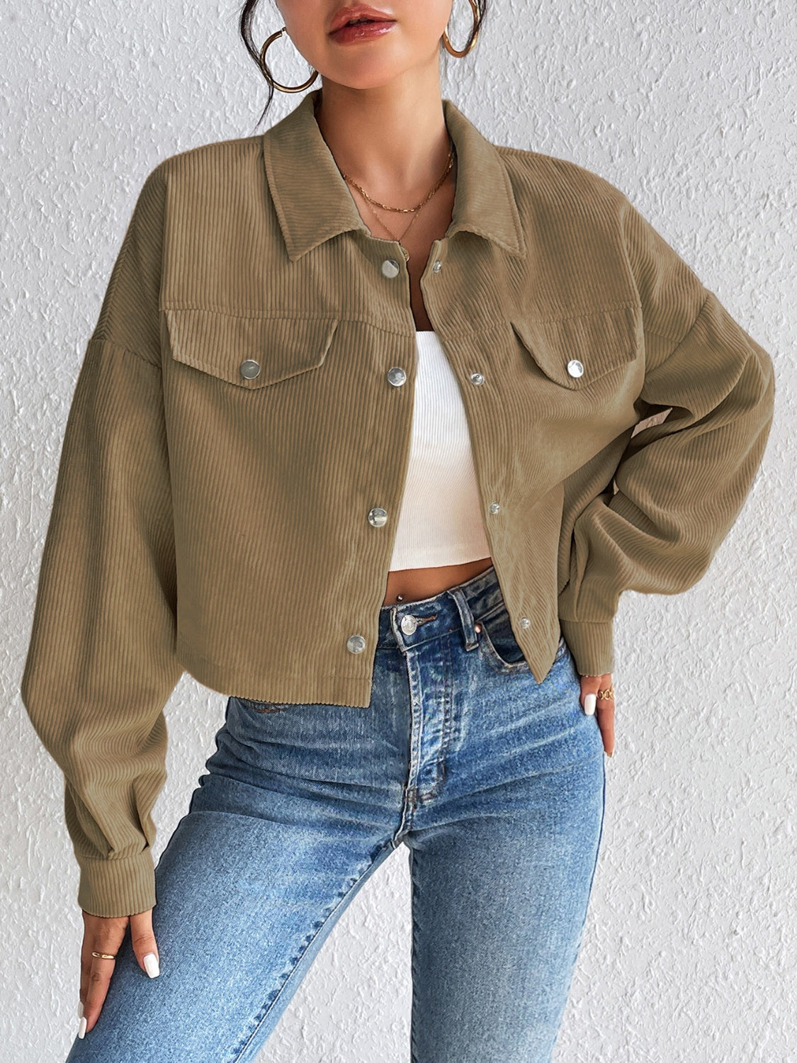Cropped taupe corduroy snap-front jacket with chest pockets and a relaxed fit.