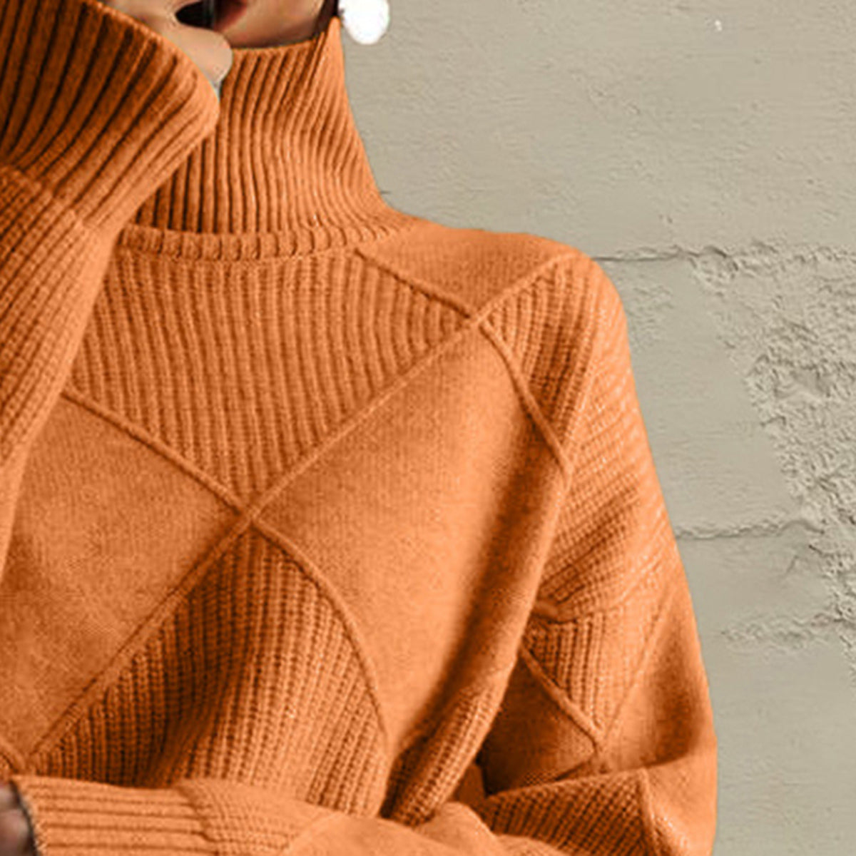 Textured diamond knit turtleneck pullover in caramel acrylic with ribbed details.