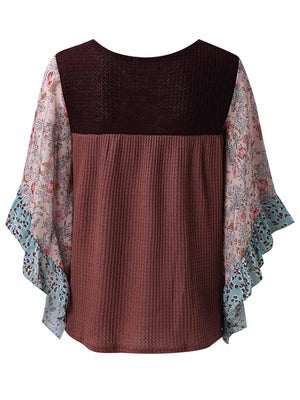 Textured panel blouse with floral print flutter sleeves and waffle knit body in mauve and black.