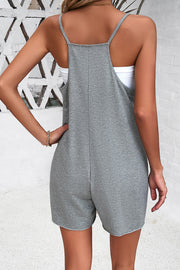 Gray relaxed romper with patch pockets and adjustable spaghetti straps.