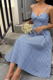 Blue gingham midi dress with knot-front bodice and spaghetti straps.