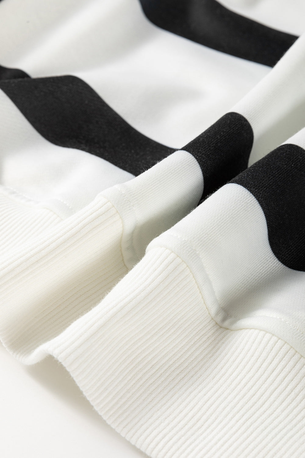 Black and white striped loungewear set with ribbed cuffs and hem detail.