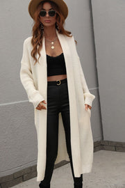 Cream textured knit maxi cardigan with pockets and long sleeves.