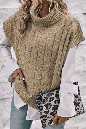Khaki cable knit turtleneck capelet sweater with ribbed trim.