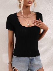 Black knit top with scalloped square neckline and short sleeves.