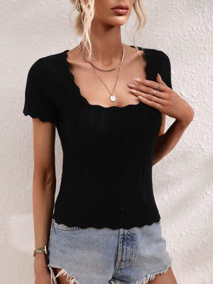 Black knit top with scalloped square neckline and short sleeves.