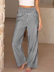 Smocked high-waist wide-leg pants in black and white gingham pattern.