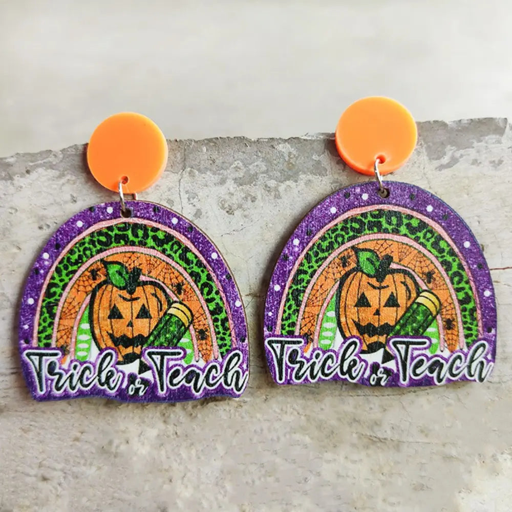 Spooky teacher rainbow earrings with pumpkins and text Trick or Teach, acrylic.