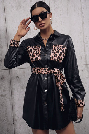 Black faux leather shirt dress with leopard print pockets, cuffs, and belt
