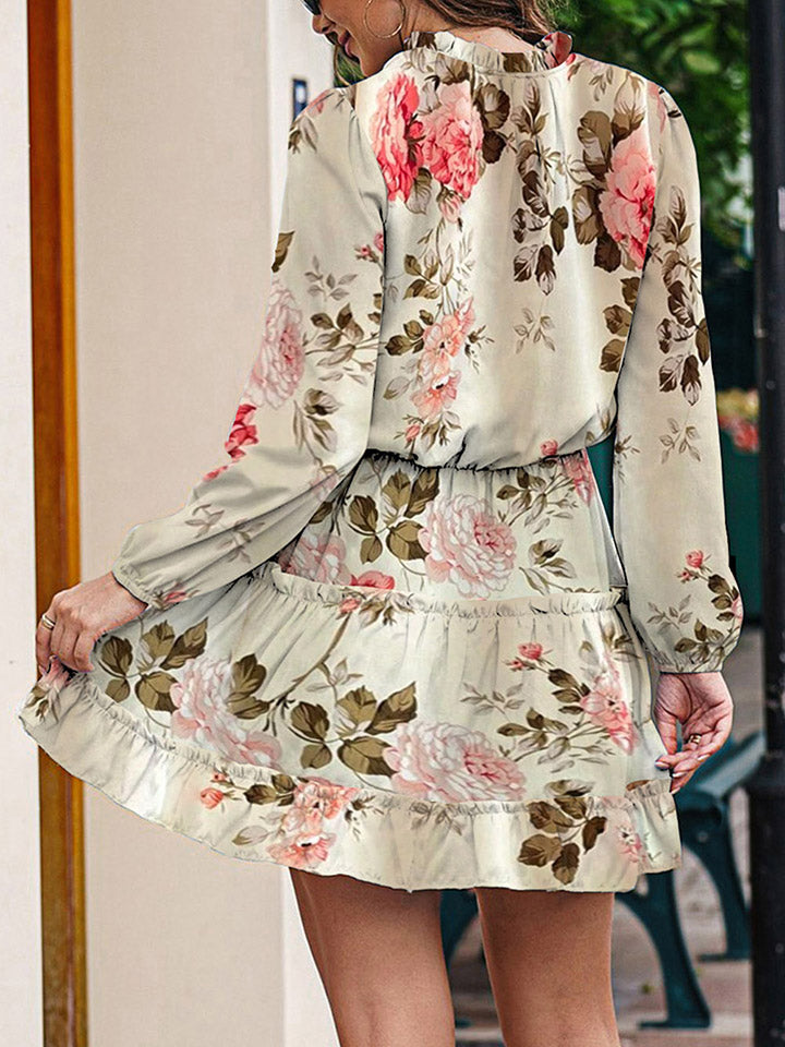 Ivory floral print tiered mini dress with ruffled hem and long sleeves.