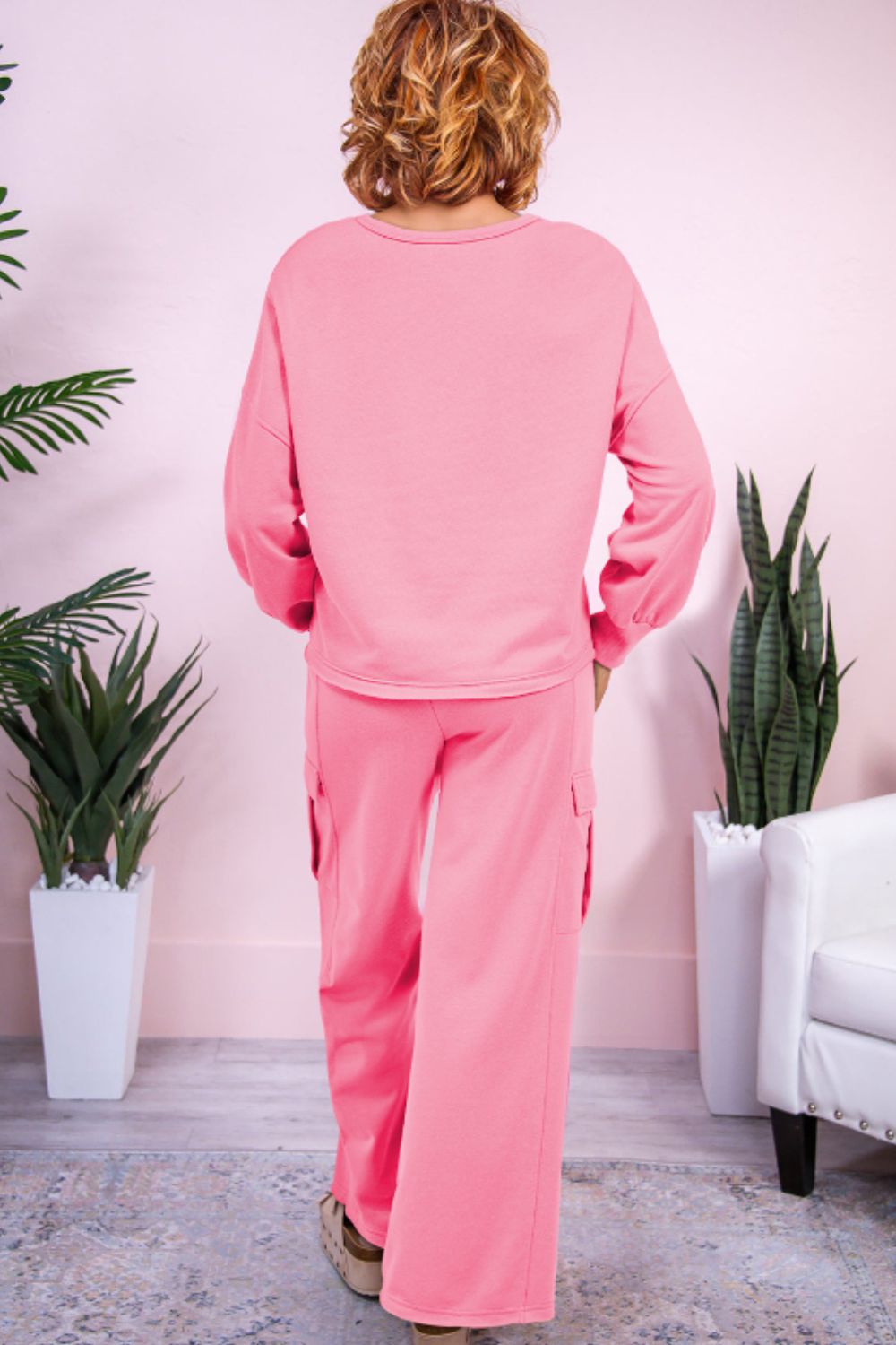Pink cargo pocket lounge set with a crewneck sweatshirt and wide-leg pants.