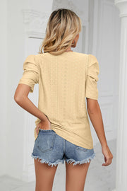 Yellow perforated sleeve volume top with puff sleeves and eyelet detail.