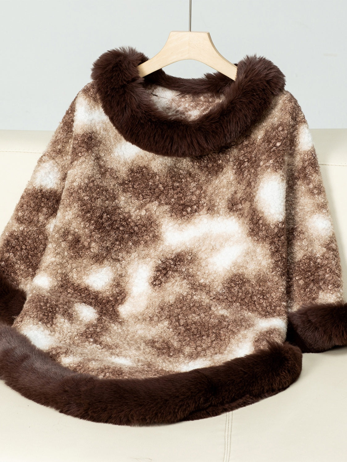 Faux fur trimmed camo poncho in chocolate brown and white, with fuzzy texture and trim.