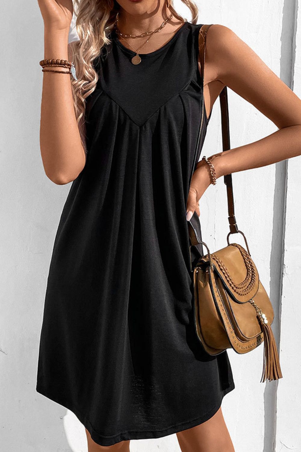 Black sleeveless trapeze dress with pleated yoke detail