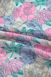 Floral print mini dress with pink, blue, and cream flowers on white fabric.
