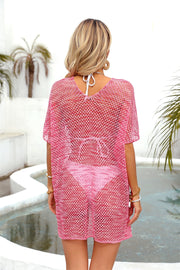 Metallic knit batwing cover-up in hot pink with a V-neck and short sleeves.