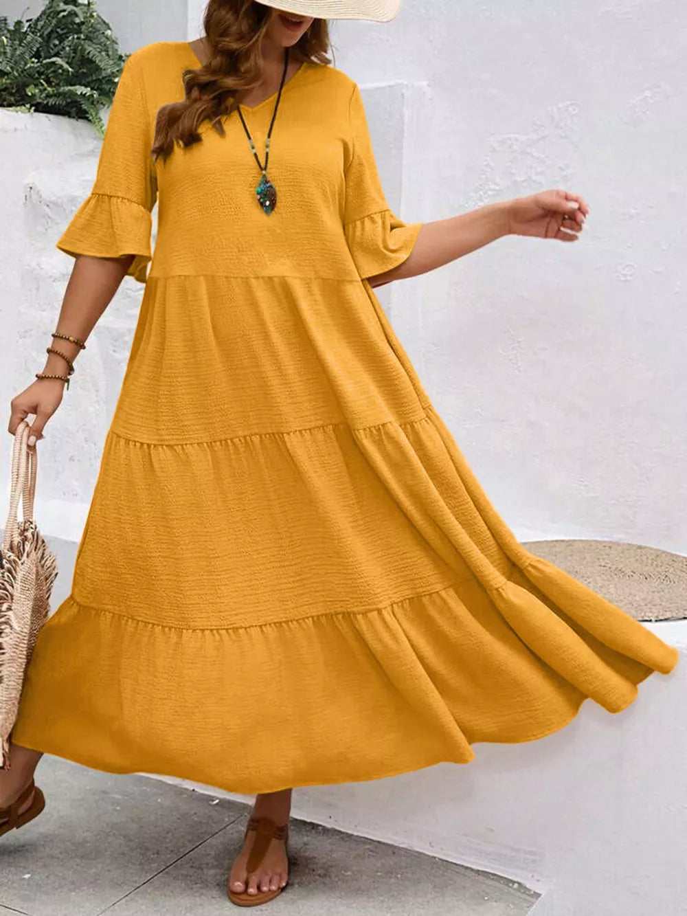 Yellow tiered midi dress with ruffle sleeves and crinkled texture
