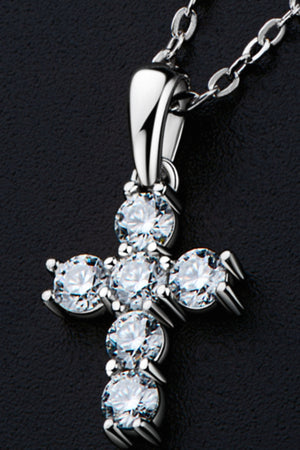 Silver cross pendant necklace with sparkling cubic zirconia stones on a delicate chain.