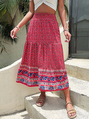 Bohemian tiered midi skirt in red with a floral print and embroidered border.