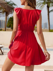 Red ruffled V-neck smocked mini dress with flutter sleeves and an a-line skirt.