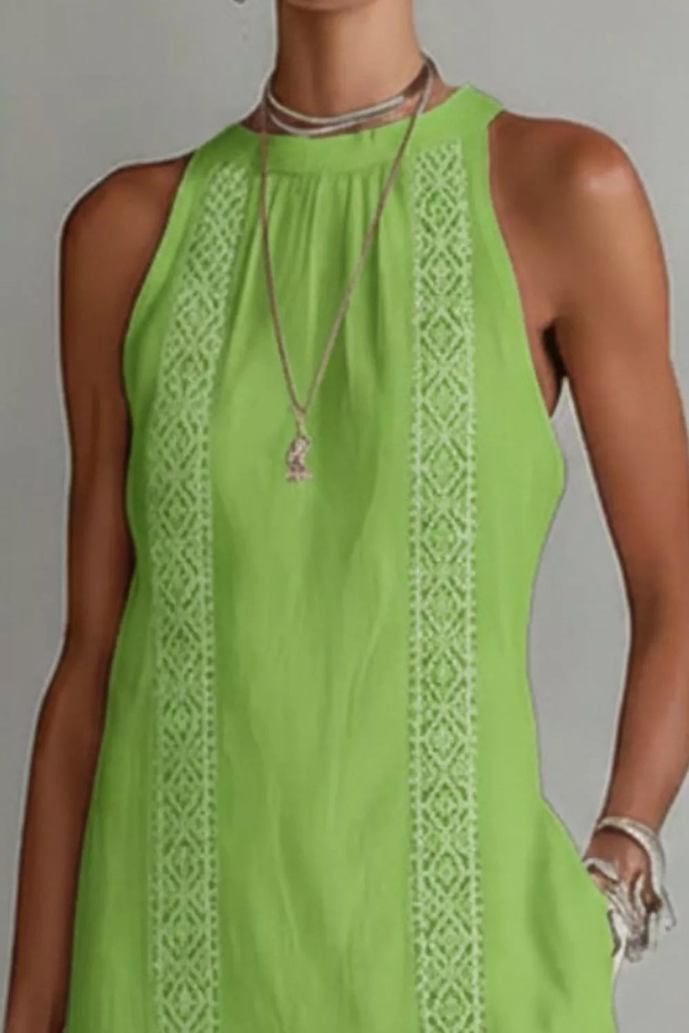 Lime green midi dress with white lace trim and pockets, sleeveless halter neck.