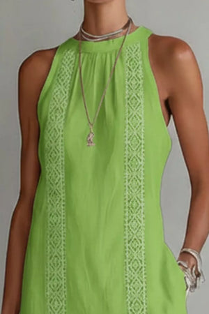 Lime green midi dress with white lace trim and pockets, sleeveless halter neck.