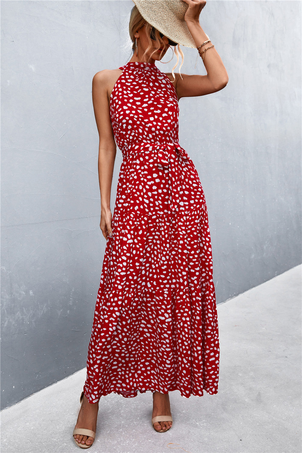 Red halter neck maxi dress with white speckle print and tie waist