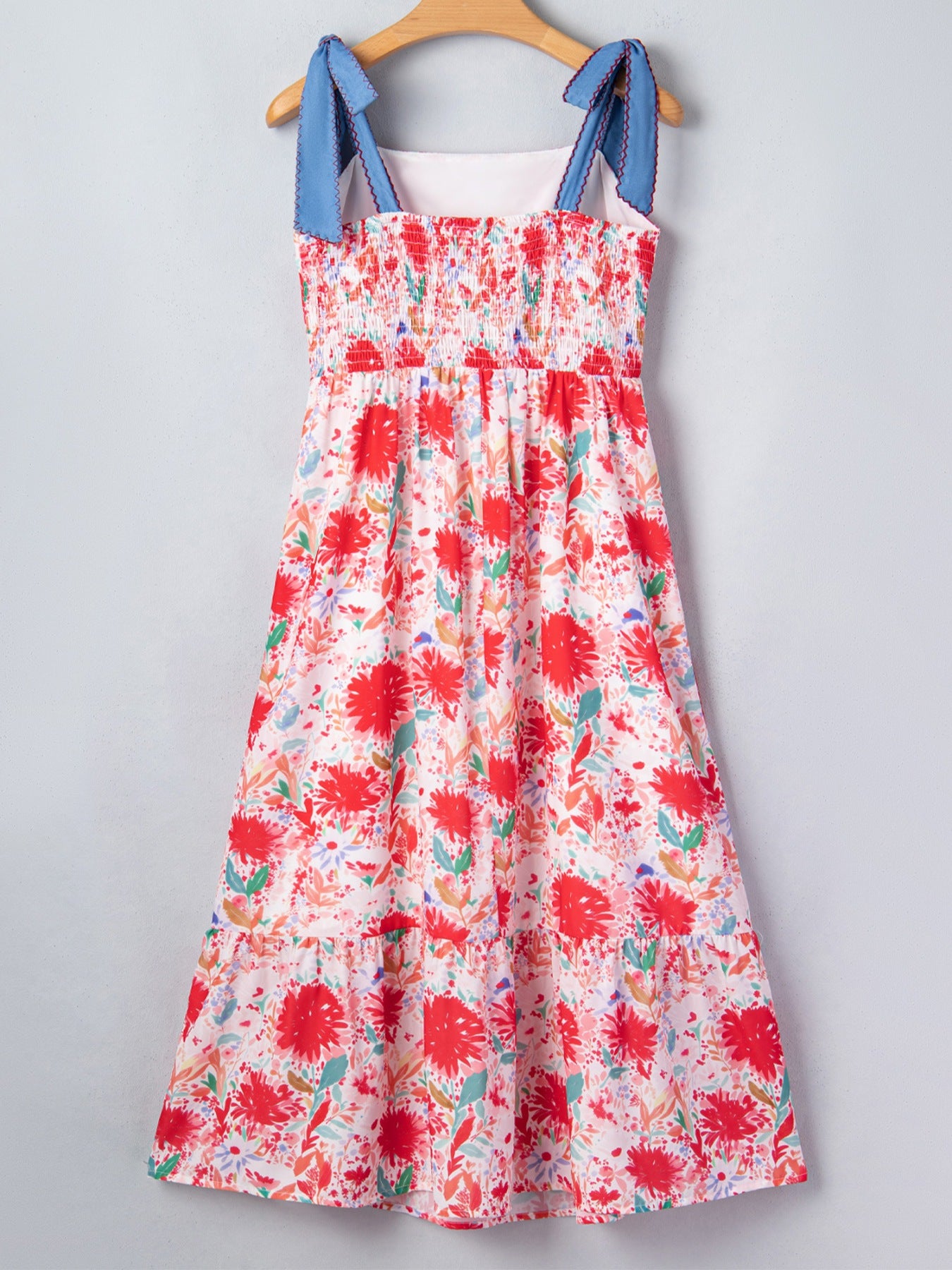 Floral print midi dress with smocked bodice and tie-shoulder straps.