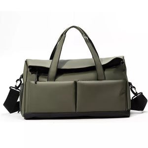 Green nylon travel duffel bag with two front pockets and adjustable strap.