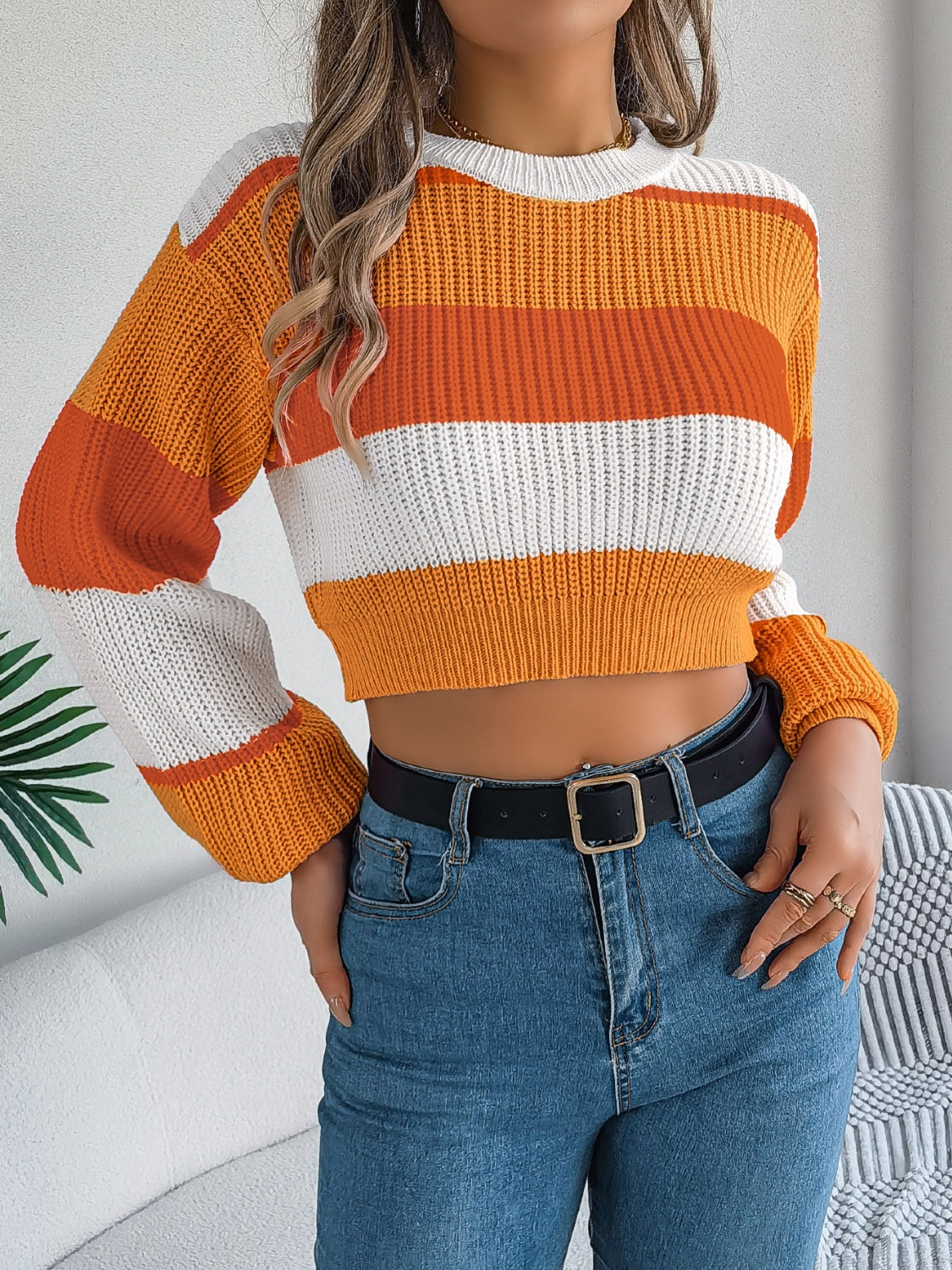 Tangerine acrylic balloon sleeve crop knit sweater with block stripes.