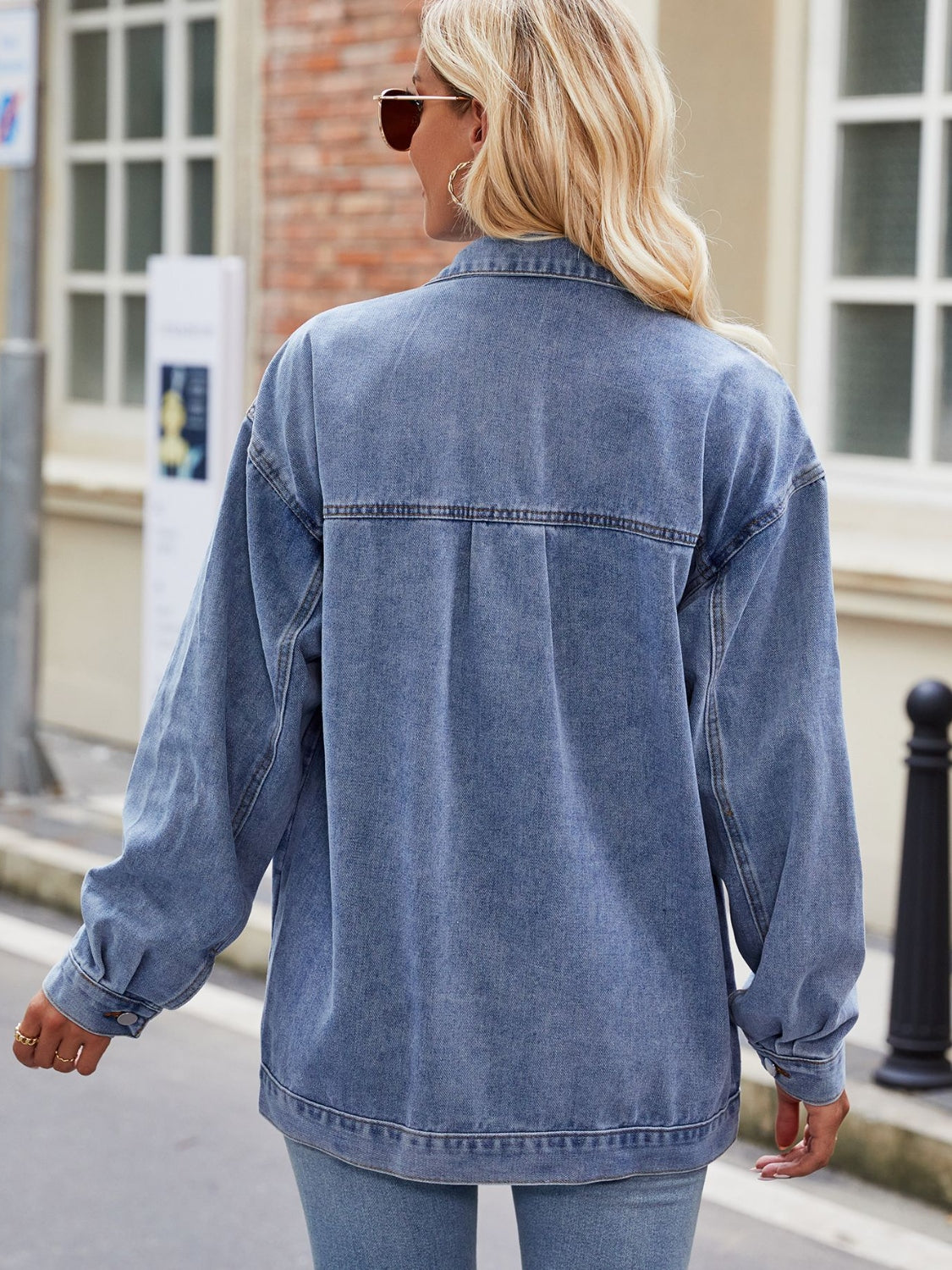 Oversized denim shacket in medium blue with button cuffs and a classic collar.