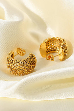 Textured gold crescent hoop earrings with a beaded, openwork design.