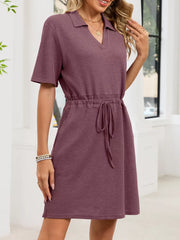 Textured polo dress in pink with short sleeves, V-neck, and adjustable drawstring waist.