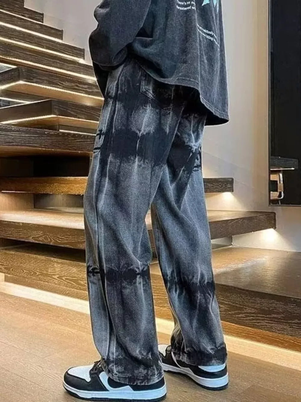Men's black distressed vintage wash wide-leg jeans with tie-dye effect