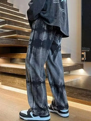 Men's black distressed vintage wash wide-leg jeans with tie-dye effect