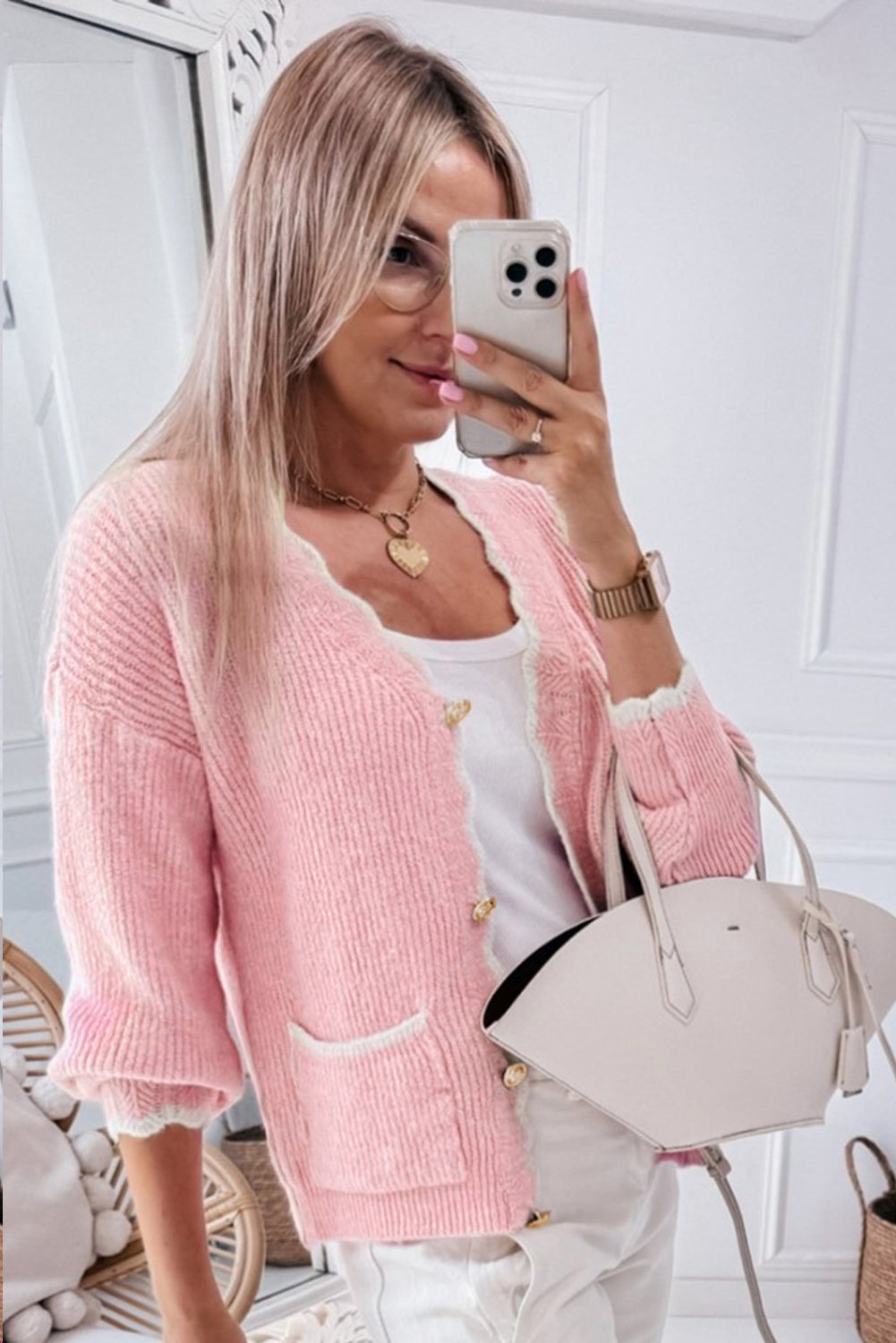 Blush pink bouclé cardigan with scalloped trim, gold buttons, and pocket details.