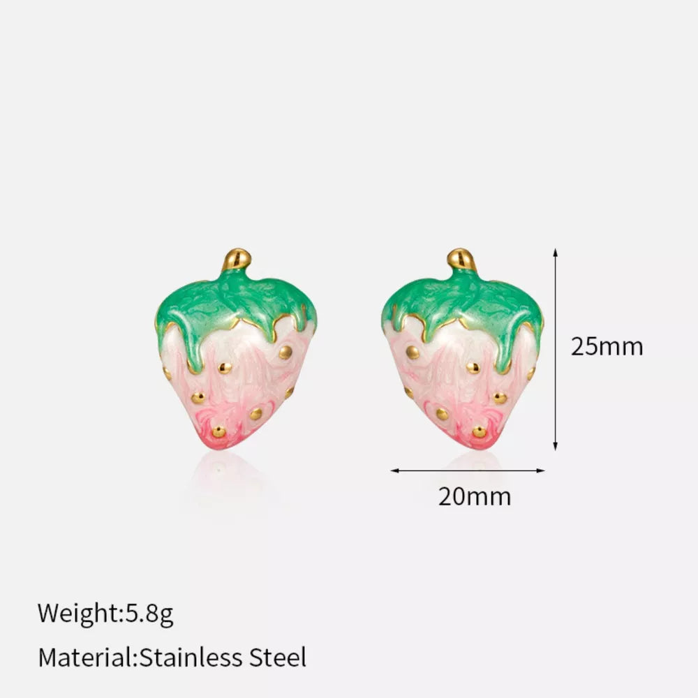 Playful strawberry charm earrings with green tops and pink bodies, featuring gold details.