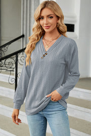 Light blue textured cable-knit henley pullover with button detail