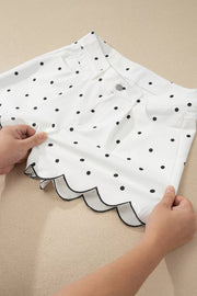 White polka dot chino shorts with black scalloped hem detail