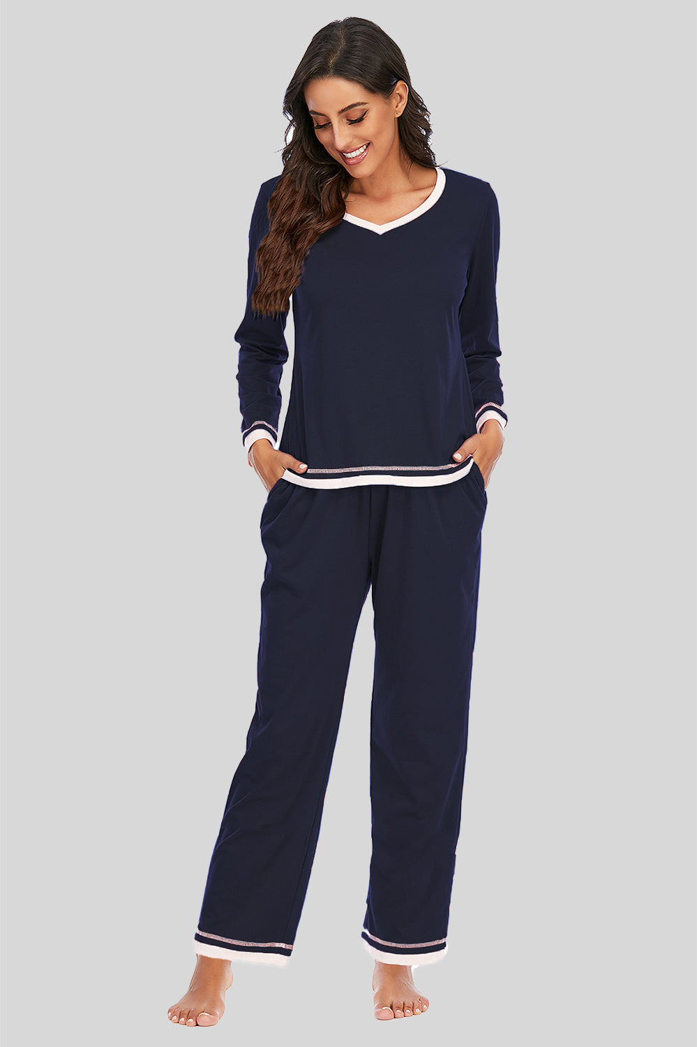 Dark navy V-neck long sleeve pajama set with white trim and striped cuffs.