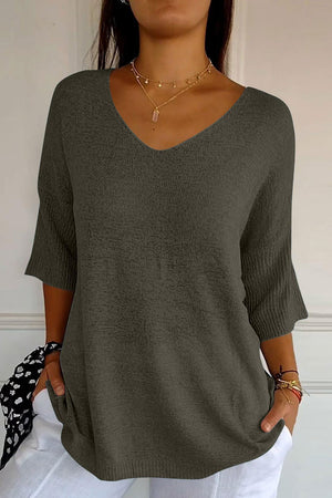 Flared sleeve v-neck knit top in dark gray with textured fabric and ribbed cuffs.