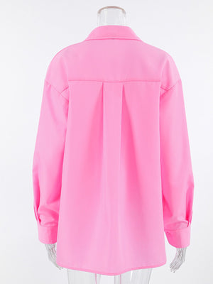Pink cotton relaxed fit shirt with pleats on the back and button cuffs.