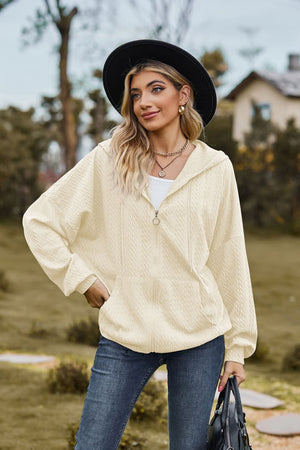 Ivory textured cable knit zip-up hoodie with a kangaroo pocket and hood.