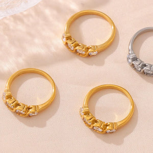 Gold and silver band rings with clear cubic zirconia stones, casual chic style.