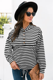 Black and white striped relaxed fit hoodie with button neck detail and drawstring hem.