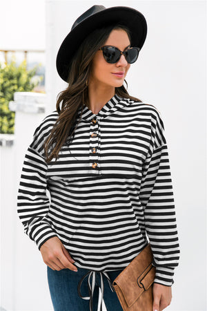 Black and white striped relaxed fit hoodie with button neck detail and drawstring hem.