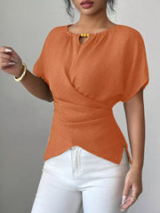 Orange short sleeve maternity blouse with beaded keyhole neckline and wrap detail